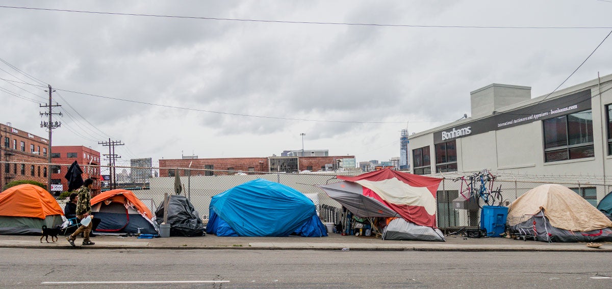 Homeless tents line city streets in San Francisco. Homeless community creates a camp with all their suitcases, tents, sleeping bags and precious belongings.