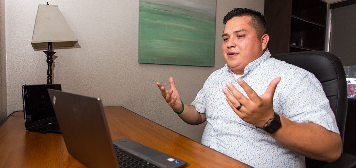 Mike Lopez, a LCSW trainee, meets with his pre-licensure supervisor by video conference.