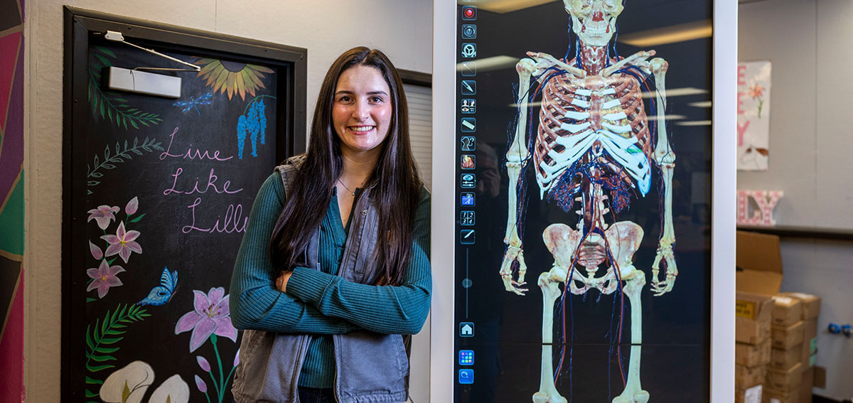 Sierra Stevens with computerized training equipment for future health care workers at Calaveras High School. She graduated from the program and is now completing her nursing education. She plans to stay in the area and work at the local hospital.